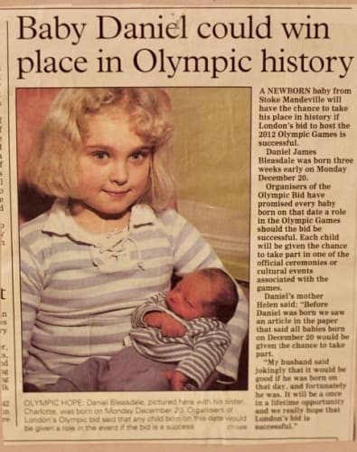 Newspaper article and photo of Daniel as a baby being held by his sister