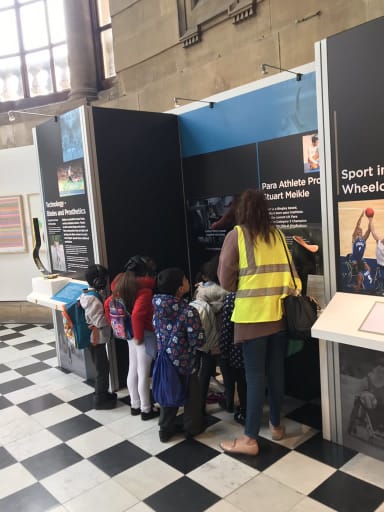 School children and teacher exploring the displays at our regional exhibition at Cartwright Hall